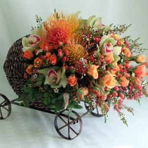 Wicker Baby Buggy Floral Arrangement by Artistry in Bloom