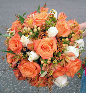 Bridal bouquet with ornange and ivory roses