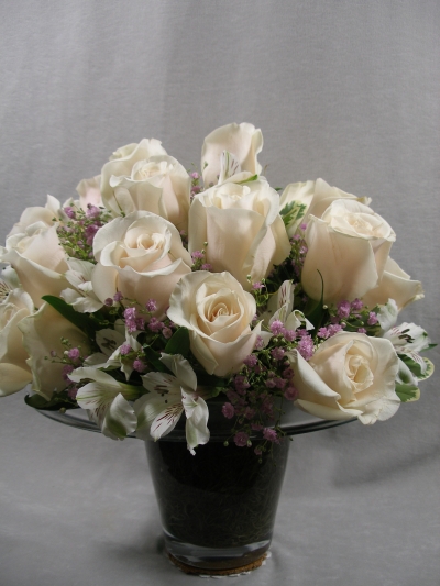 Glass top hat vase with roses