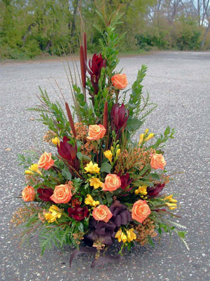 Symp. with orange roses, safari sunset, yellow freesia.