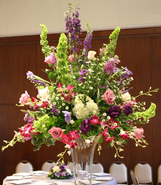 Tall glass pedestal centerpiece for wedding