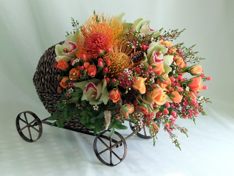 Wicker Baby Buggy Floral Arrangement by Artistry in Bloom